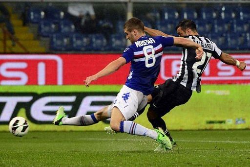 Juventus' forward Fabio Quagliarella (R) scores in spite of Sampdoria's defender Shkodran Mustafi on May 18, 2013